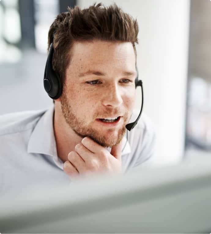 Male receptionist working with laptop
