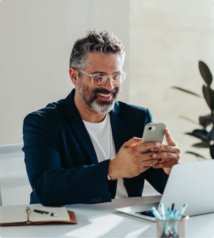Man smiling at his phone